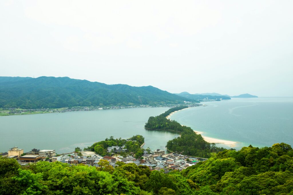 Amazing scenery of Amanohashidate sandbar covered with pine trees and connecting Miyazu Bay surrounded by green hills