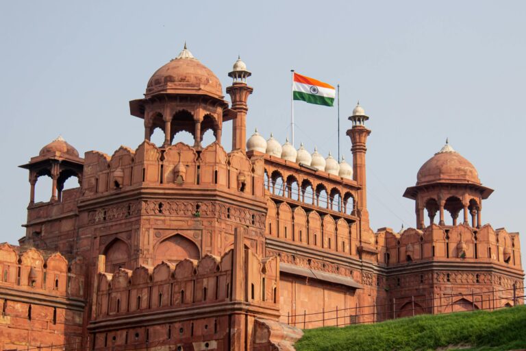 Front view of the historic Red Fort in New Delhi with the Indian flag waving.