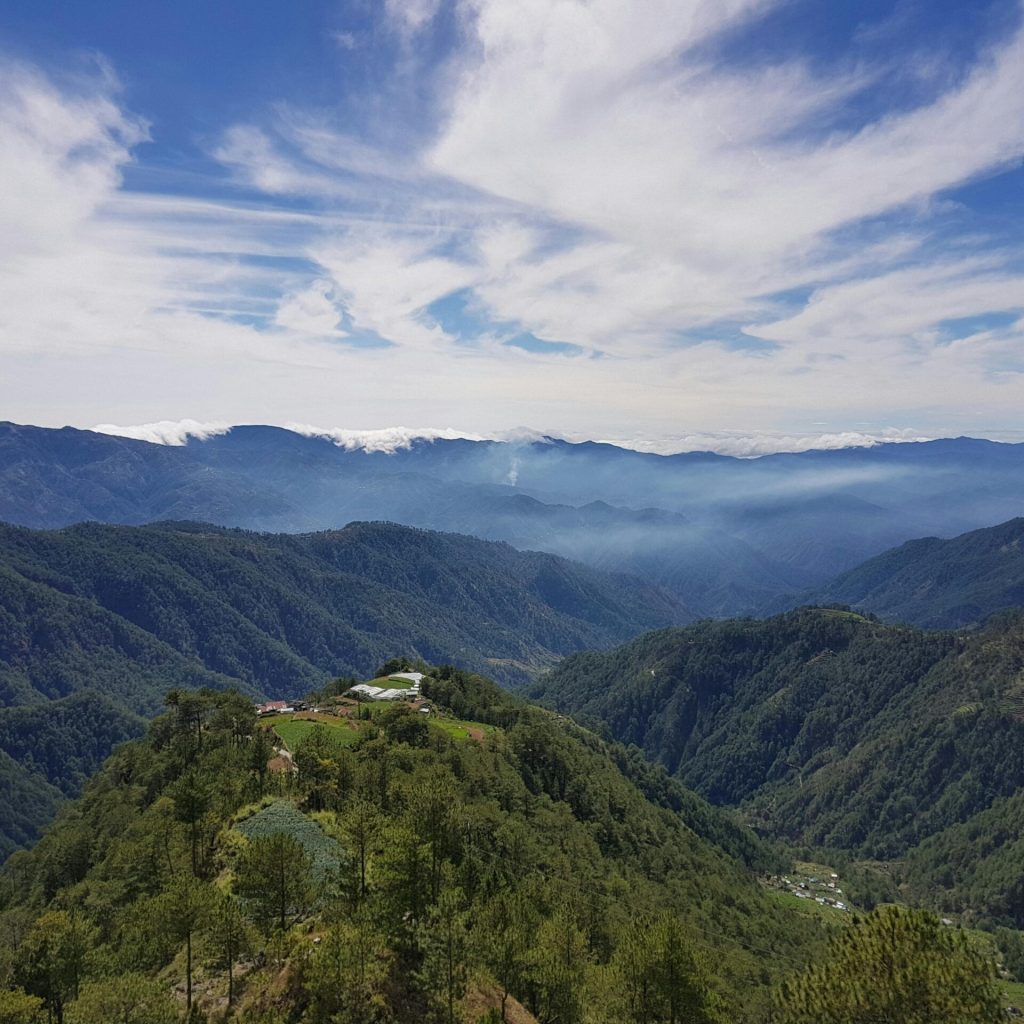 Breathtaking mountain landscape in Atok, Philippines with clear skies and lush greenery.